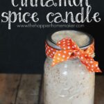 A cinnamon spice candle with orange ribbon