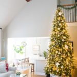 living room with very tall christmas tree