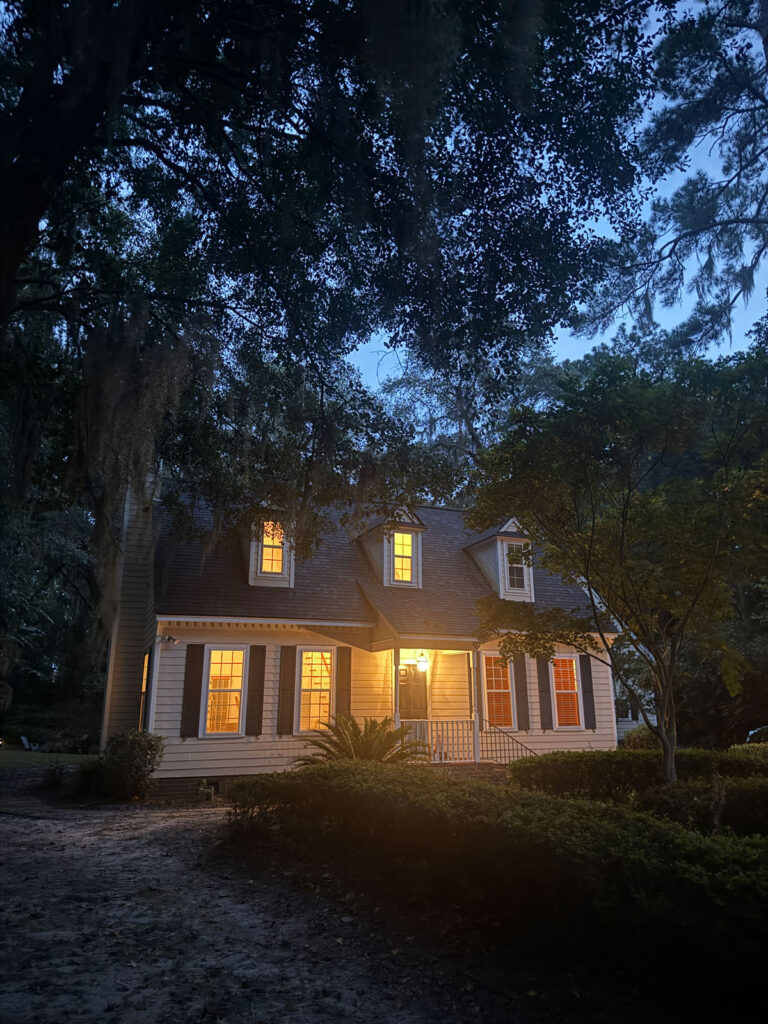 house at night with interior lights on