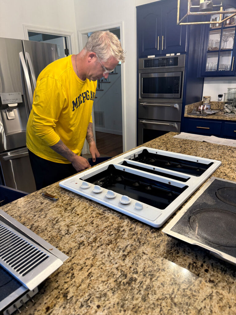 man removing white cooktop