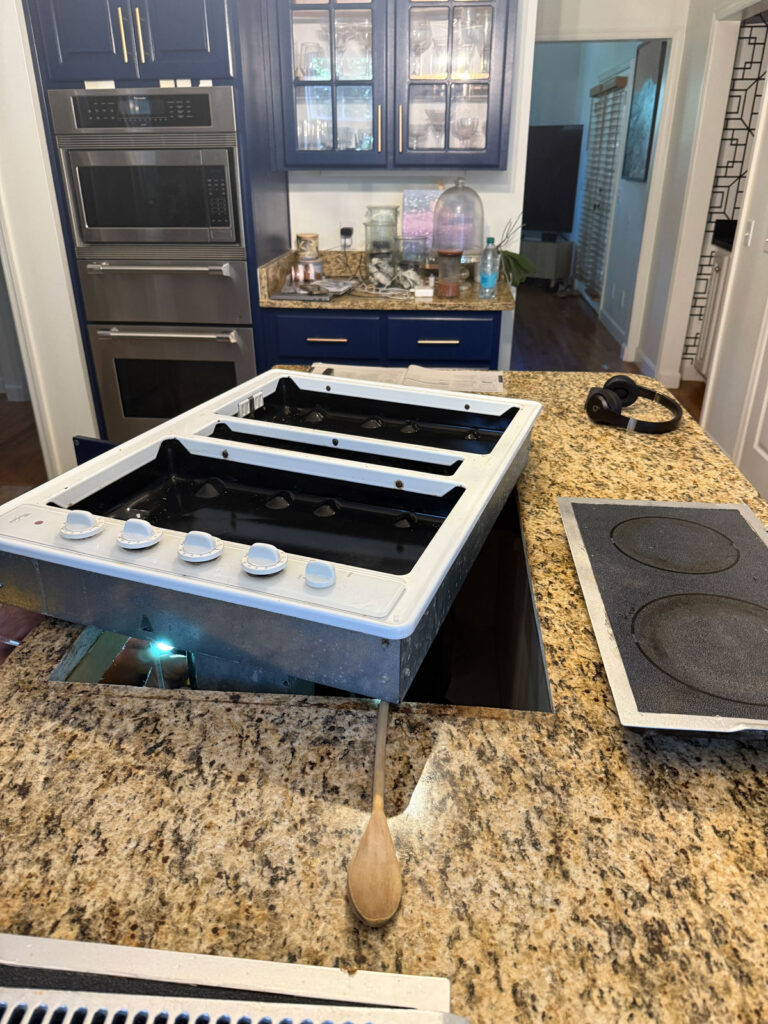 white cooktop removed from countertop