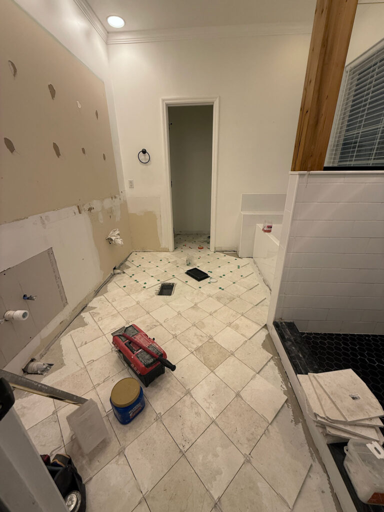 tile being laid in a bathroom
