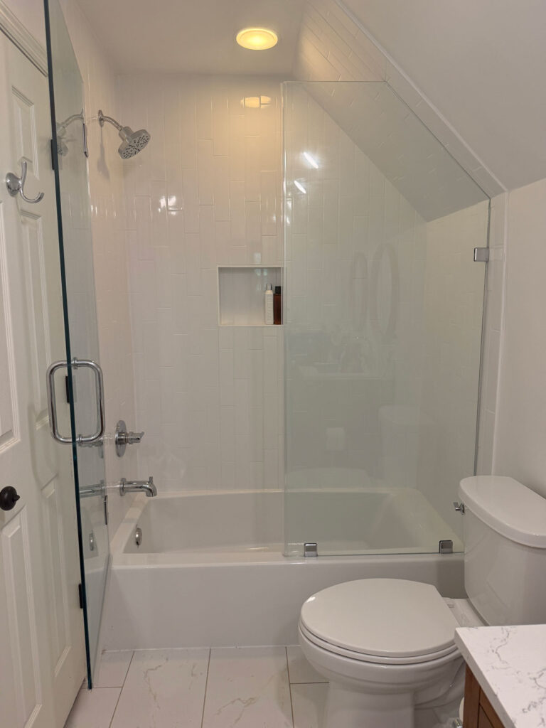 white tiled bathtub/shower combo