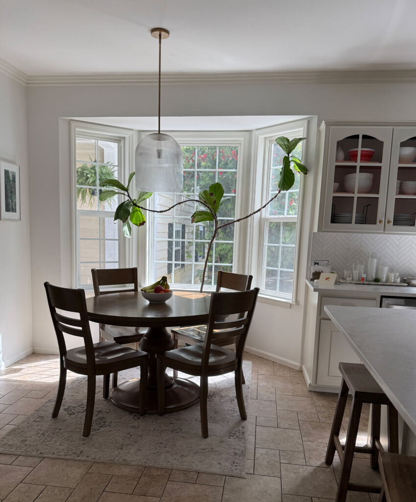 eat in kitchen with bay window and fluted glass pendant light