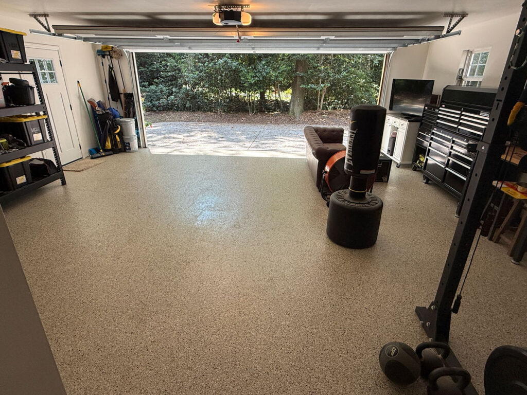 garage with coated floor and garage door open