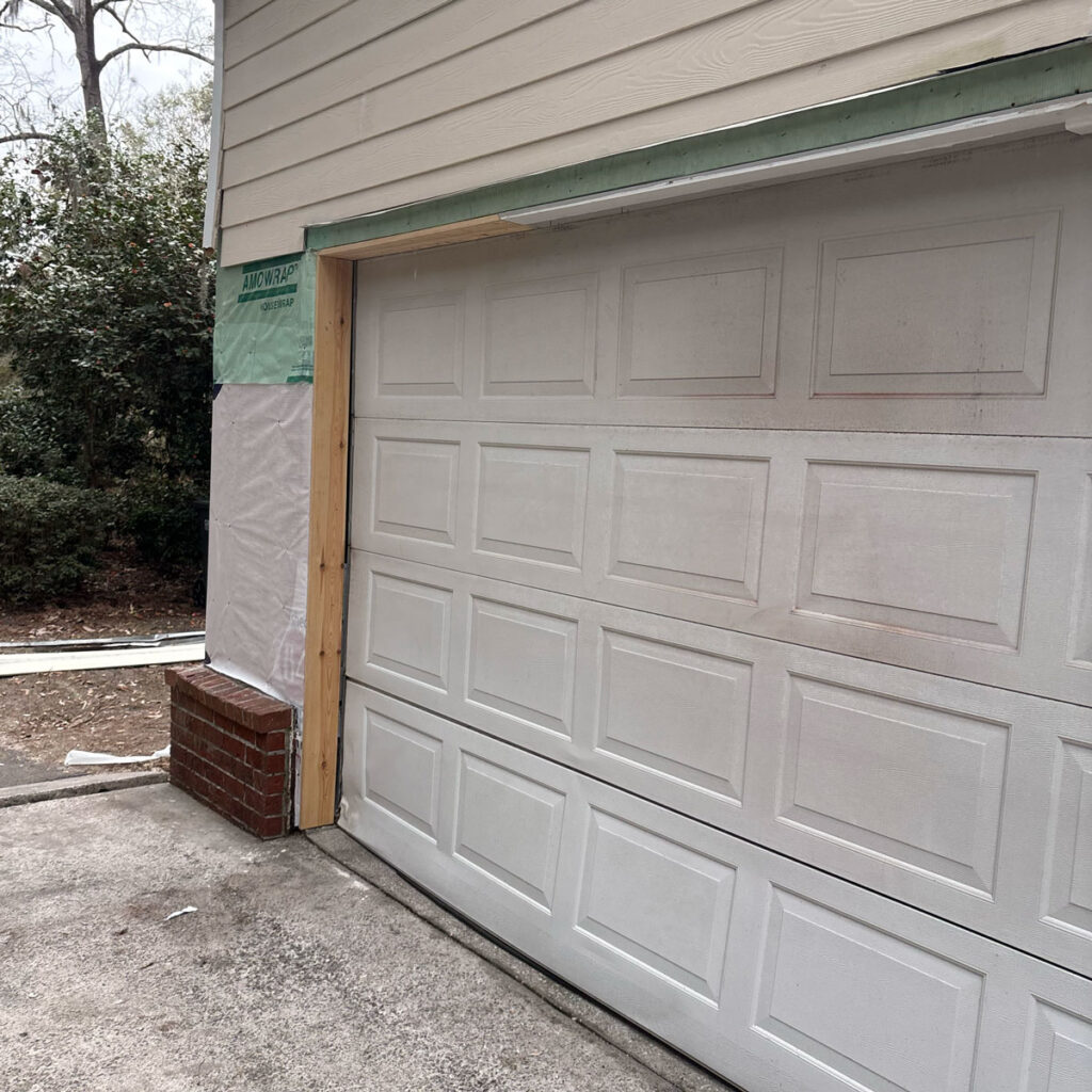 garage with siding repair happening