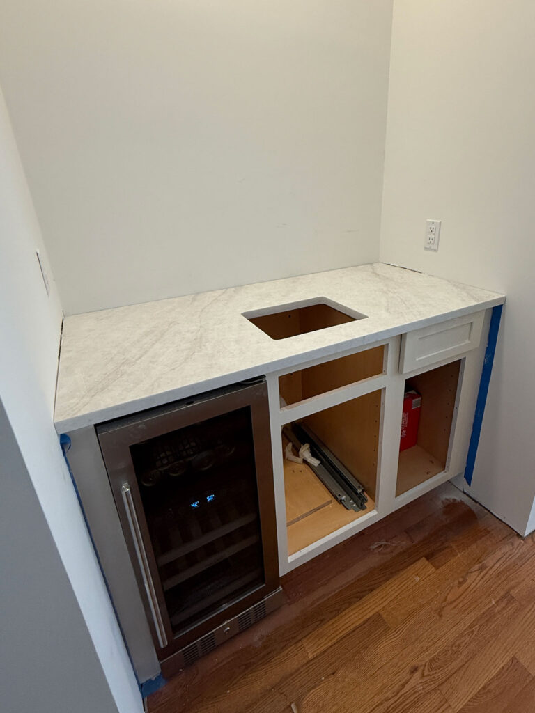 wet bar installation with brushed quartz countertop
