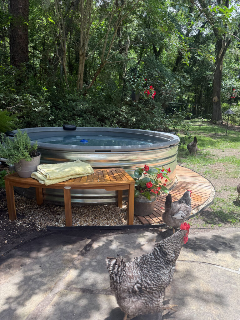 stock tank pool with wood walkway and bench
