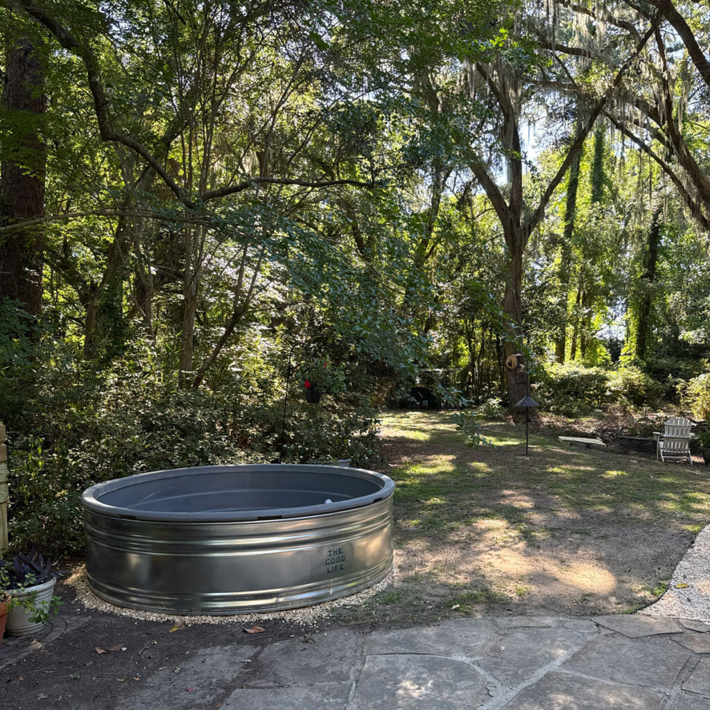 stock tank pool placed on rocks in yard